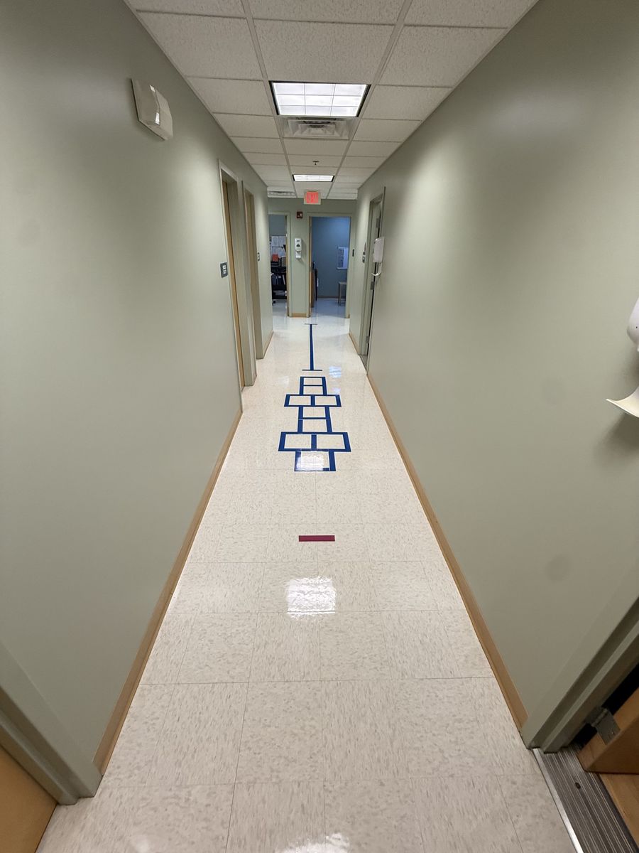 Hallway VCT floor shining after strip and wax in Massachusetts