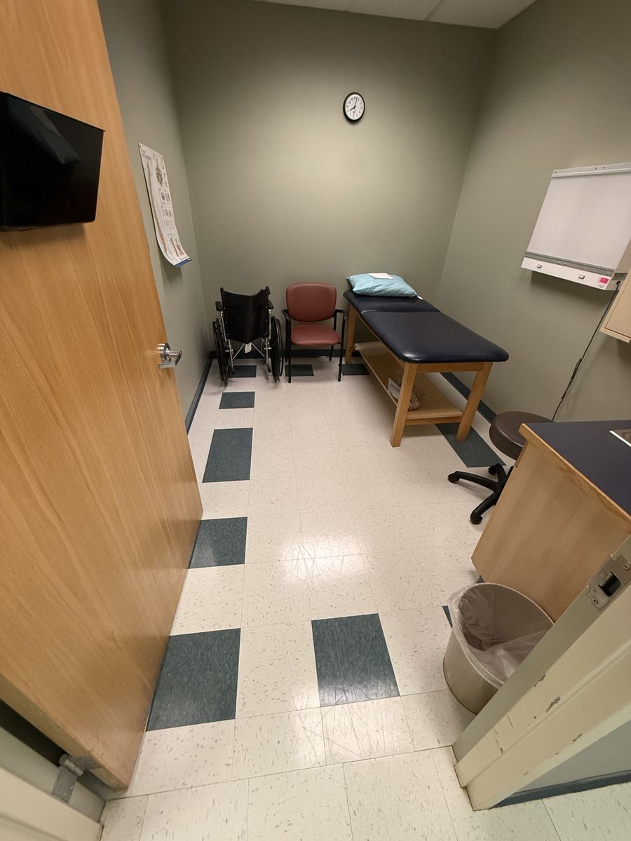 Clinic exam room floor before stripping and waxing